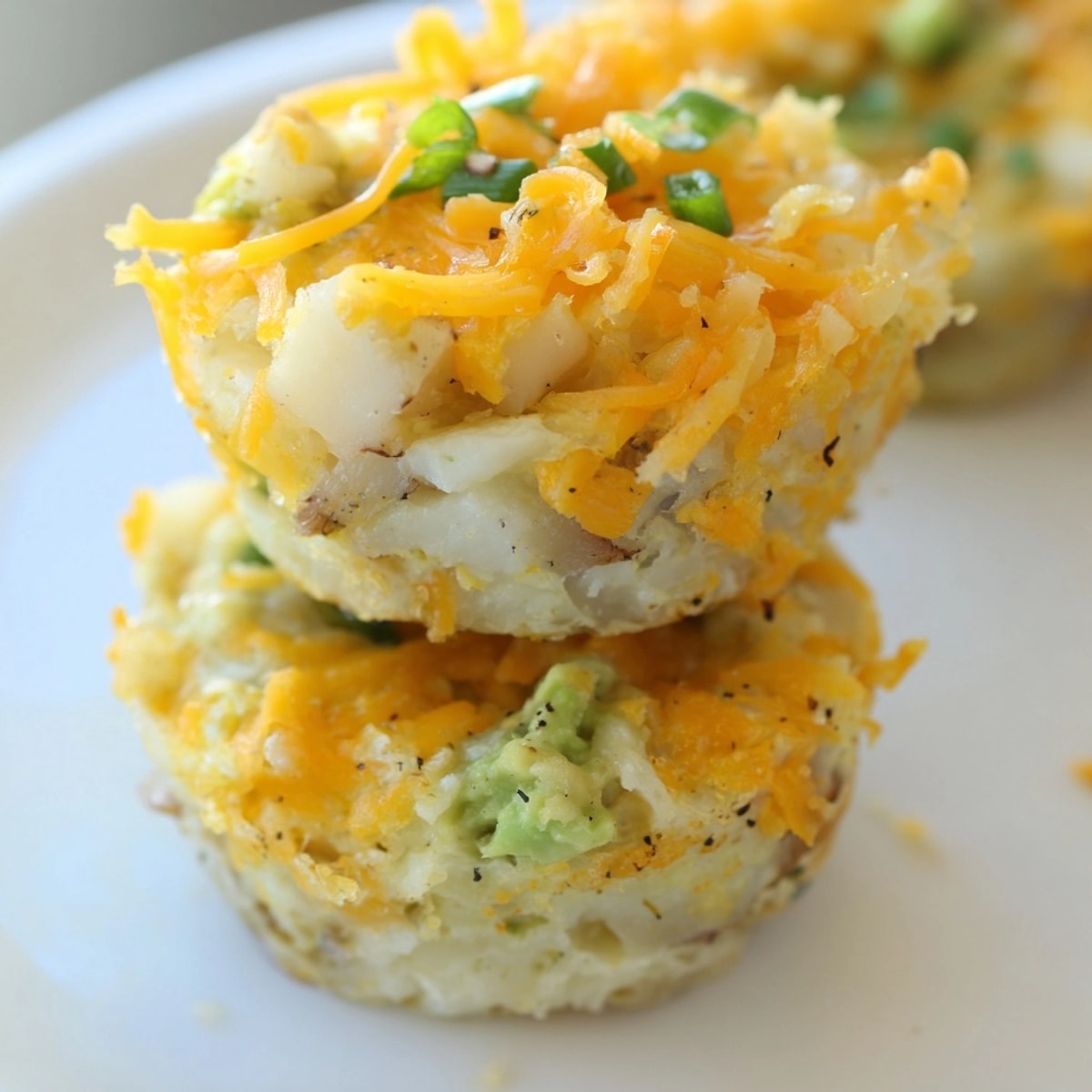Golden Avocado Ranch Potato Egg Muffins, fresh from oven, speckled with herbs.