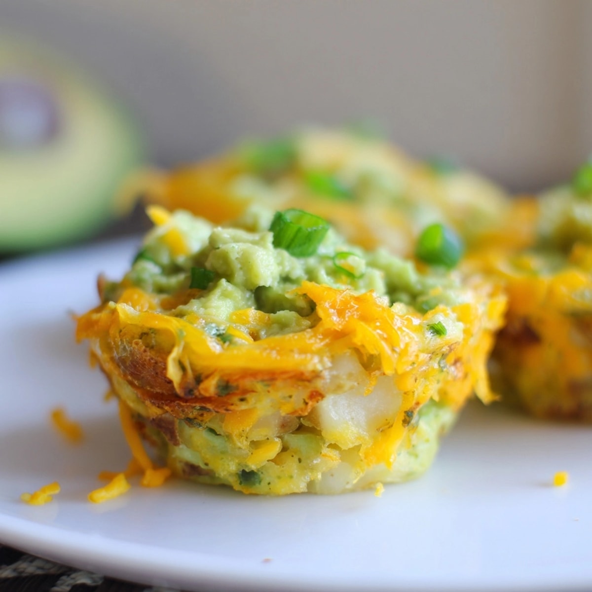 Creamy Avocado Ranch Potato Egg Muffins with melted cheese, served warm for brunch.