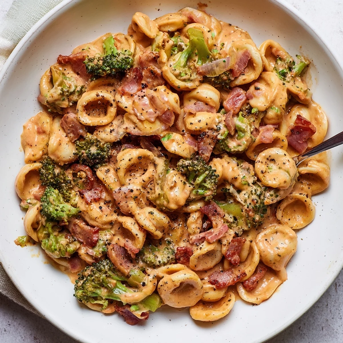 Flavorful Spicy Bacon Broccoli Orecchiette pasta dish with crispy bacon and creamy sauce.