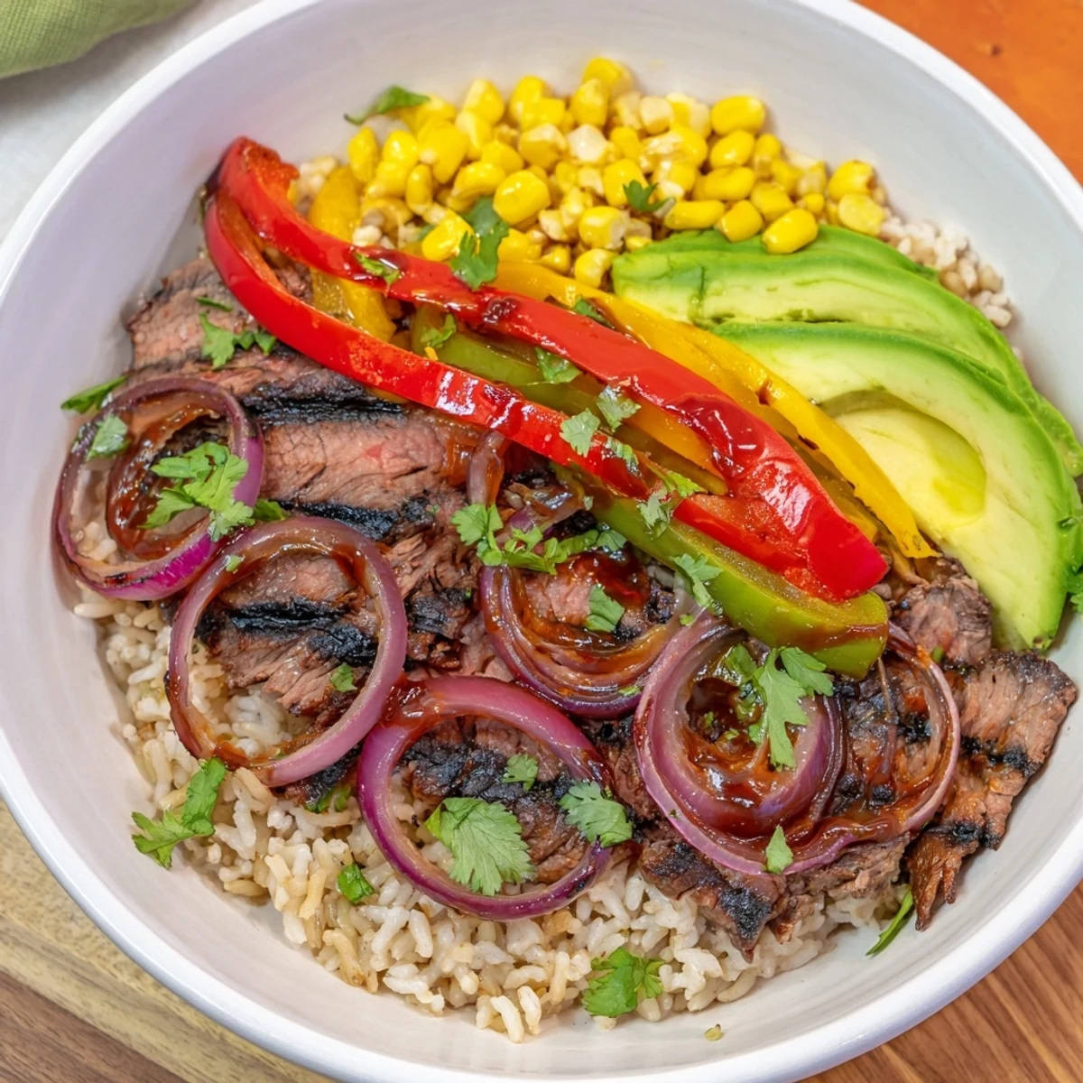 Smoky BBQ Steak Fajita Bowl with tender steak, vibrant peppers, fluffy rice, and fresh toppings.