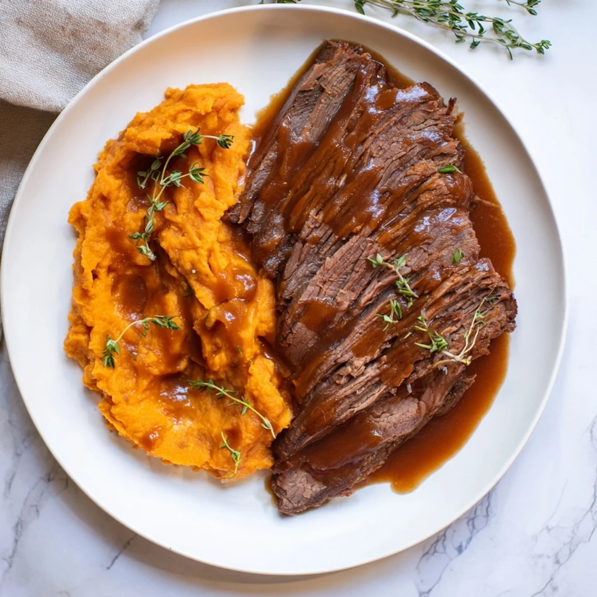 A close-up of sliced Classic Brisket & Mashed Sweet Potatoes, showcasing juicy meat and a vibrant vegetable side.
