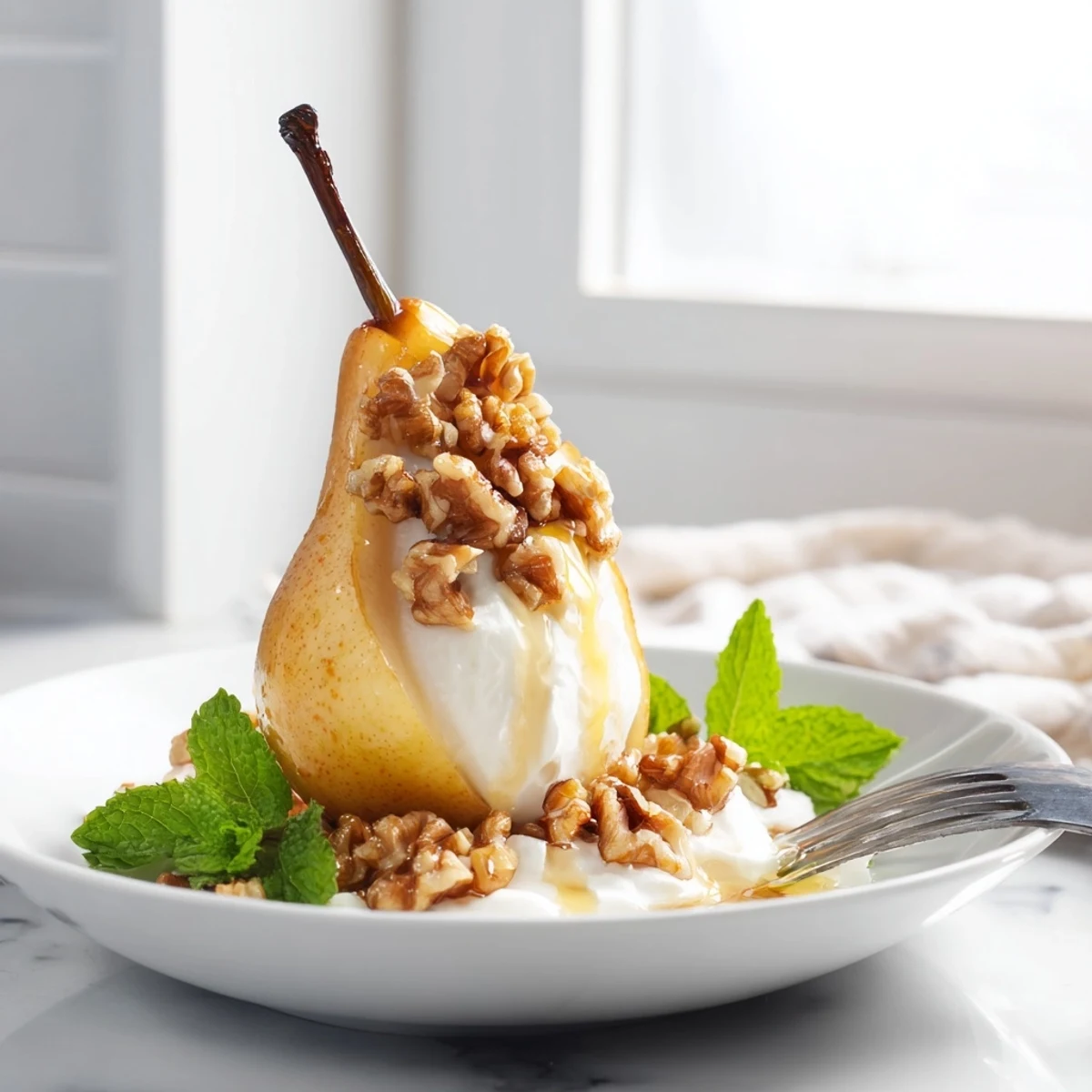 Warm, caramelized Roasted Pears with cinnamon, walnuts, and creamy Greek yogurt perfect for dessert.