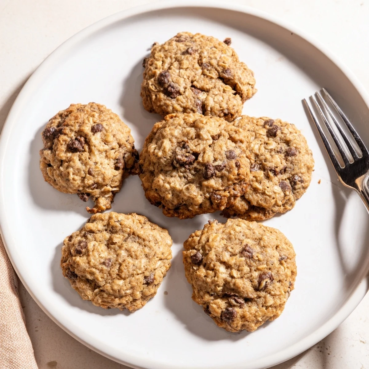 Warm, golden Oat-Banana Chocolate Chip Cookies, featuring melty chocolate and a soft, chewy texture.