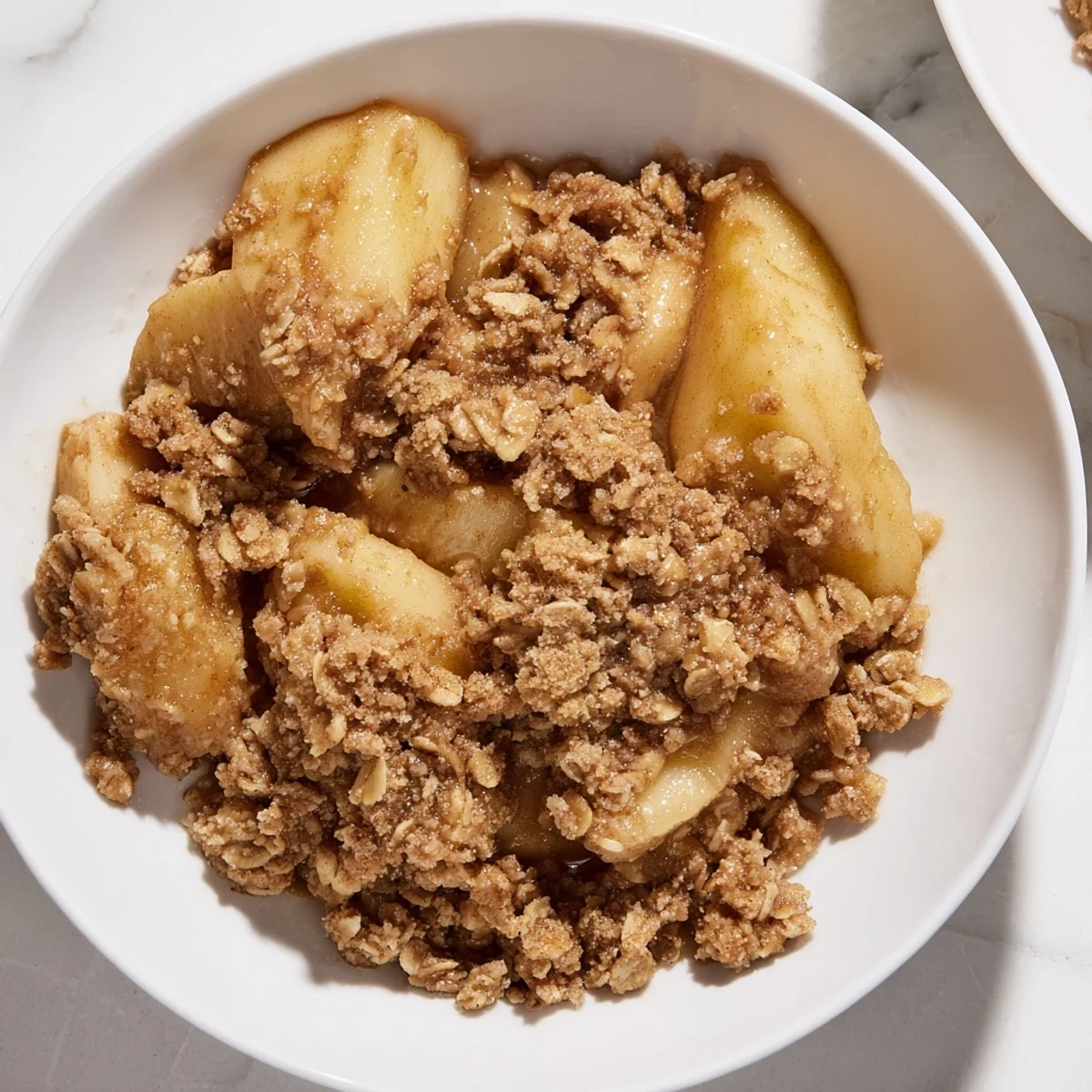 Golden brown Apple Crisp with a bubbly, cinnamon-infused apple filling ready to serve.