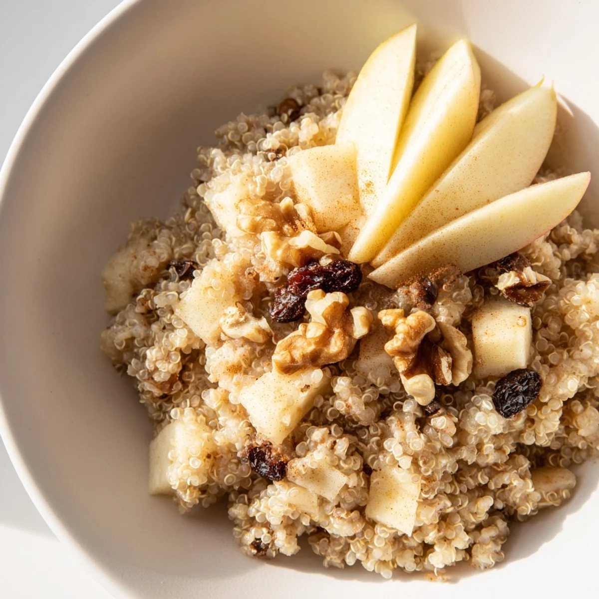 Freshly made Apple Cinnamon Quinoa Bowl, featuring fluffy quinoa and sweet diced apples, ready to be enjoyed.