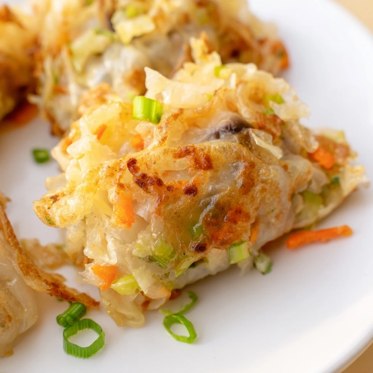 Golden brown Crispy Rice Paper Dumplings, sizzling in a pan to create a delightful, crunchy texture.