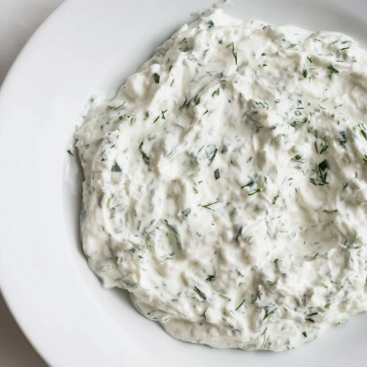 Creamy Greek Yogurt Herb Dip served with crisp veggies and crunchy pita chips for a fresh snack.
