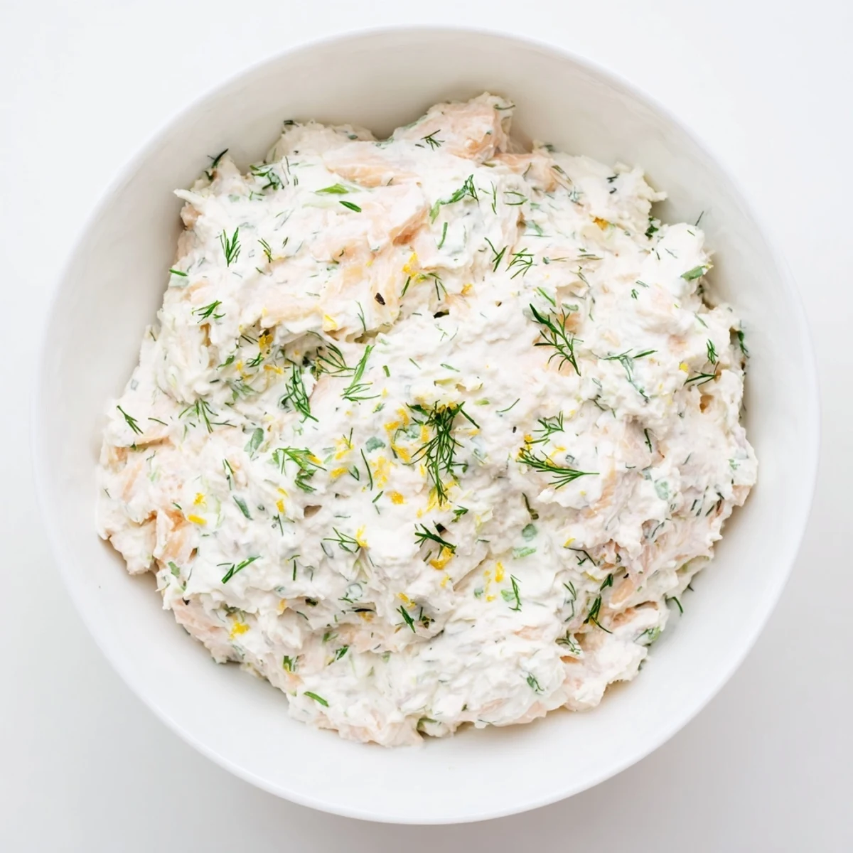 Elegant smoked salmon dip served as an appetizer with cucumber slices and rye crackers for a gluten-free friendly snack.