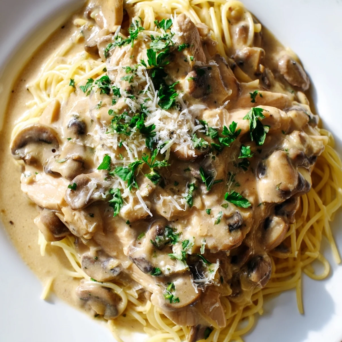 Steaming bowl of creamy mushroom chicken spaghettini with sautéed cremini mushrooms, garlic, and Parmesan, ready for a comforting Italian-inspired dinner.