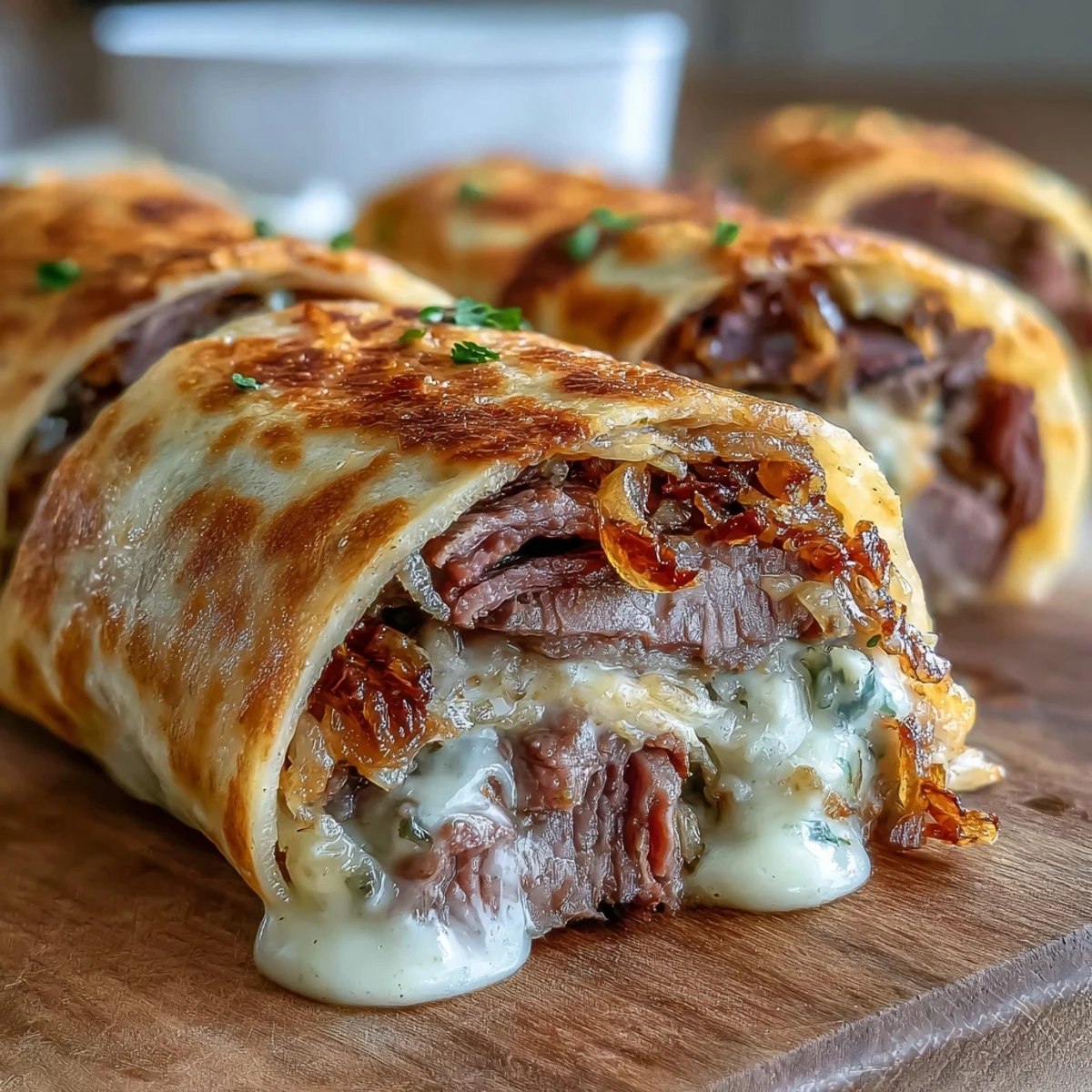 Golden baked tortilla roll ups stuffed with savory roast beef, melted cheese, and crunchy fried onions, paired with rich dipping sauce.