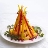 This Bonfire Warmth Centerpiece features vivid orange, yellow and red produce, perfect for festive gatherings and snacking.