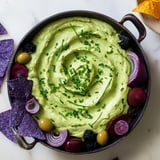 A beautifully styled Witch's Brew Cauldron appetizer, ready for Halloween, with fresh colorful dippers ready alongside.