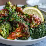 Sizzling harissa broccoli florets roasted to charred perfection served on flatbreads with fresh cilantro.