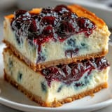 Bright and zesty no-bake lemon blueberry cheesecake bars ready to be sliced.