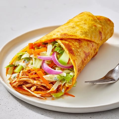 Air Fryer Buffalo Turkey Christmas Wraps are golden brown, filled with turkey and veggies.