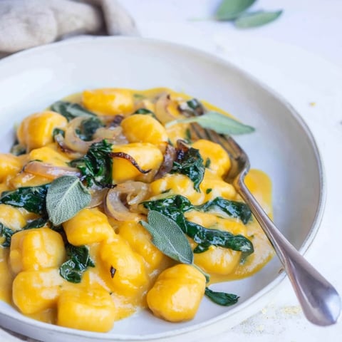 Warm, creamy One-Pot Pumpkin Sage Gnocchi, glistening with Parmesan, ready for a comforting dinner.