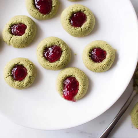 Matcha Cranberry Shortbread Thumbprint Cookies: buttery, green cookies filled with vibrant red cranberry jam.