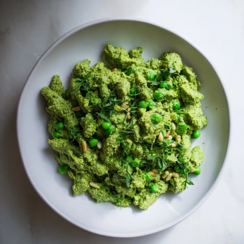 A bowl of vibrant Green Pea & Spinach Pasta, a healthy and creamy vegetarian meal.