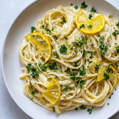 Lemon-Garlic Greek Yogurt Pasta, creamy and bright, is showcased with fresh parsley and lemon.