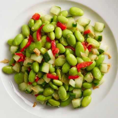 Chilled edamame salad with sesame seeds, a refreshing summer dish featuring crisp cucumber.