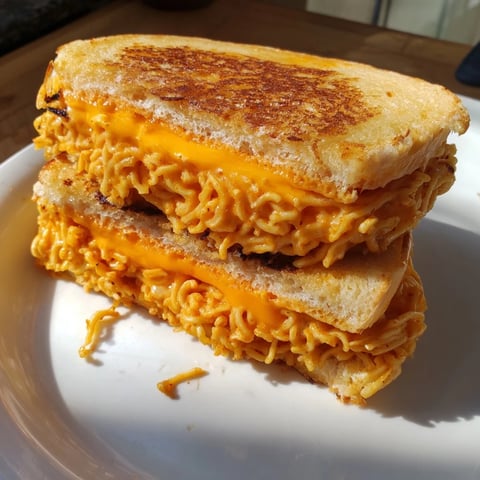 Golden and crispy Instant Ramen Grilled Cheese, oozing with melted cheese and ready to eat.