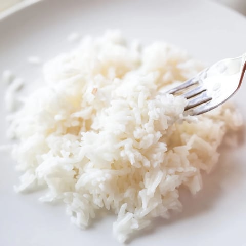 Fluffy Coconut Jasmine Rice, featuring creamy texture, invites pairing with flavorful curries and stir-fries.