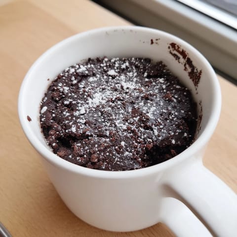 A fluffy and moist chocolate Microwave Mug Cake, perfectly portioned for a quick, sweet treat.