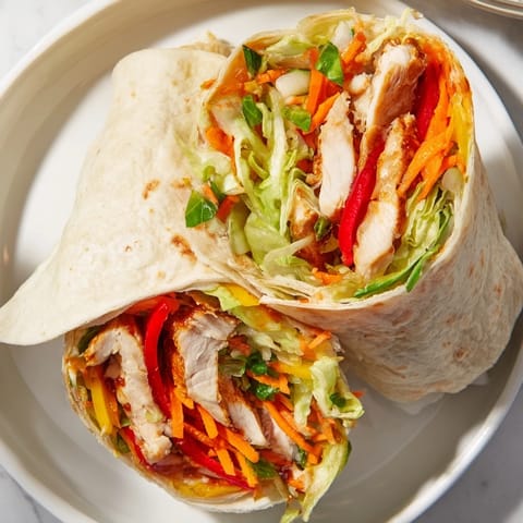 Beautifully arranged teriyaki chicken wrap, showing off juicy chicken and a perfect tortilla roll.