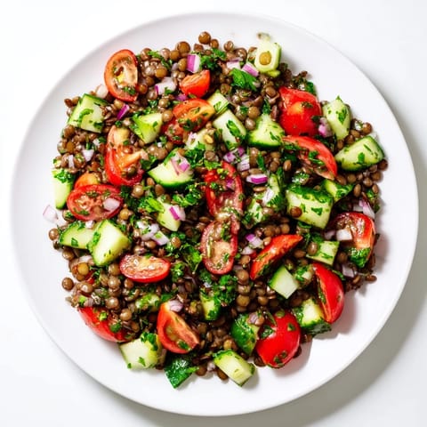 Enjoy a refreshing Lentil Salad featuring tender lentils and a vibrant mix of fresh vegetables.
