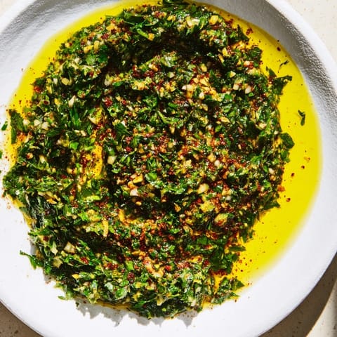 A spoonful of the flavorful Moroccan Chermoula Marinade, showcasing a mix of herbs and citrus, ready to transform any dish.