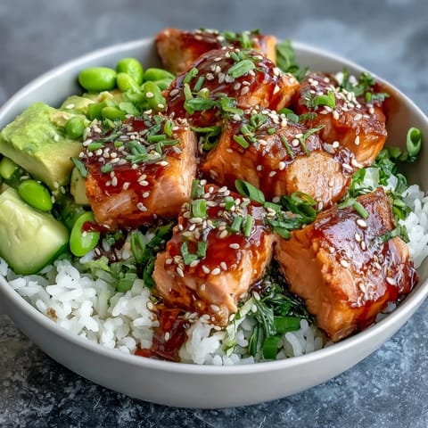 Vibrant salmon rice bowl featuring marinated salmon, crisp vegetables, and creamy avocado, ready to serve for dinner.