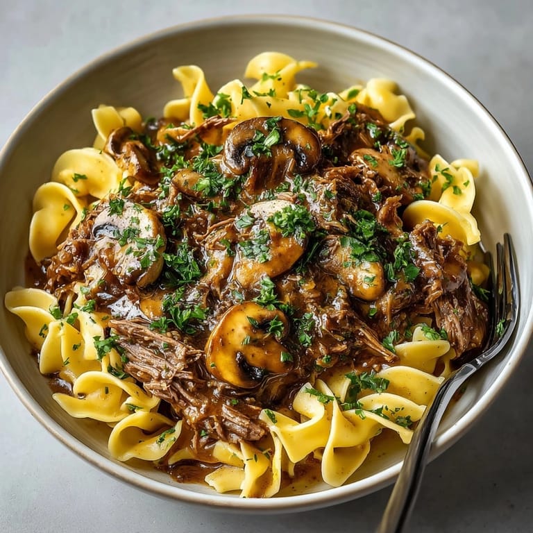 Imagine tender beef and earthy mushrooms in Slow Cooker Gravy, perfect for noodles.