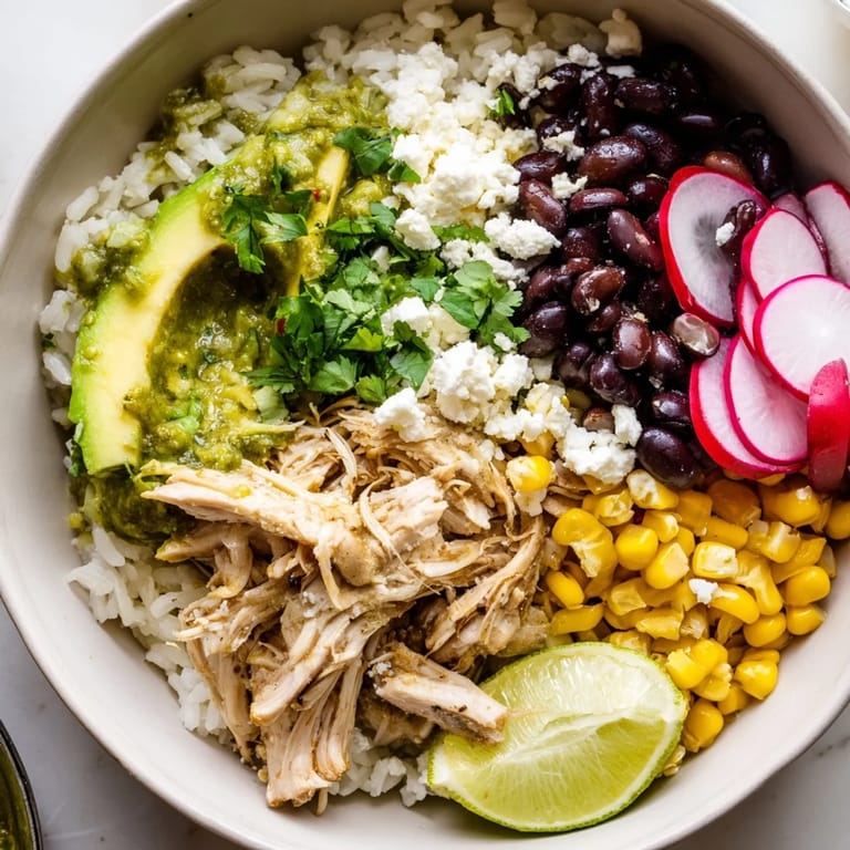 Delicious Green Enchiladas Rice Bowl featuring shredded chicken and zesty green sauce.  
