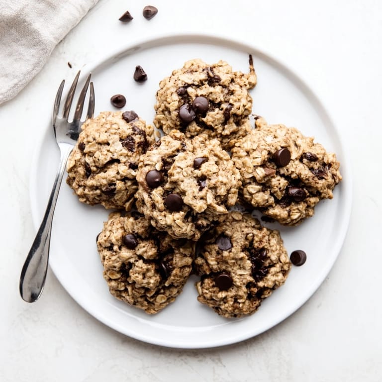 A stack of freshly baked Oat-Banana Chocolate Chip Cookies, perfect for a sweet and easy dessert.