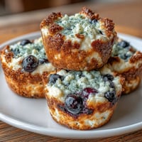 Protein-packed mini cottage cheese blueberry bites baked with oats and lemon zest, perfect for healthy snacking.  