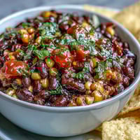 Colorful 3-ingredient Cowboy Caviar Dip with black beans, sweet corn, and fresh pico de gallo in a serving bowl.  