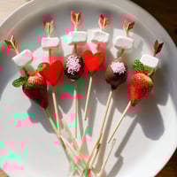 A vibrant Cupid's Arrow Candy Tray, showcasing dipped strawberries, heart gummies, perfect for Valentine's Day.